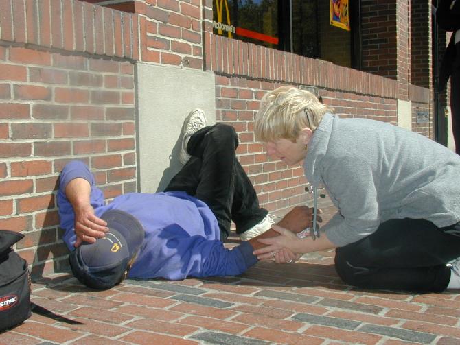 Nurse works with patient during street outreach