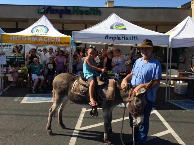 Child and Man with donkey at health fair